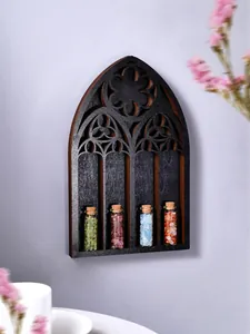 Close-up detail of a Gothic arched wooden wall shelf with four crystal stone vials inside.