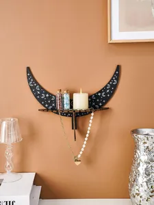 Lifestyle view of a wooden crescent moon shelf used for jewelry and candle display.