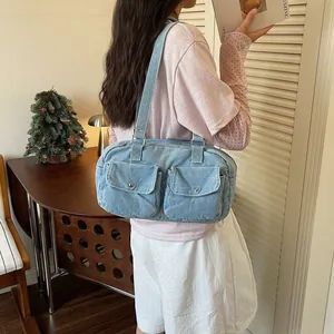 Stylish large capacity light blue denim Boston bag featuring two front flap pockets