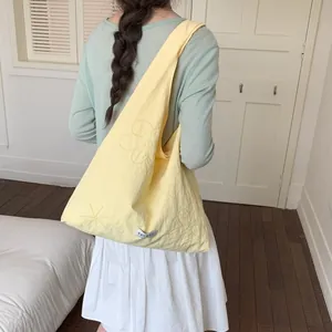 Stylish pale yellow nylon tote bag featuring floral embroidery and large capacity