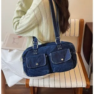 Fashionable large capacity blue denim Boston bag with front pockets and long shoulder straps