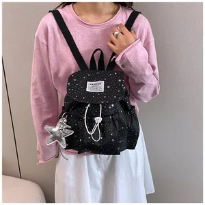 Mini black backpack with white star pattern and silver star charm for women and girls
