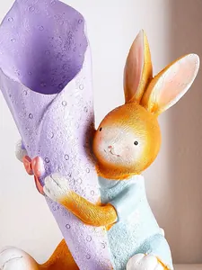 Close-up of a resin Easter rabbit figurine hugging a purple bouquet-shaped vase.