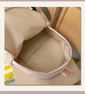 Close-up of the spacious interior lining of a pink checkered school backpack
