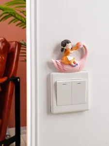 Detailed view of fairy tale swan girl resin ornament mounted on a white wall switch