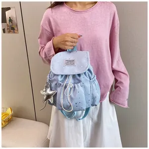 Light blue mini backpack with star patterns featuring a cute silver star keychain charm