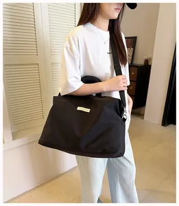 Borsa da viaggio nera capiente per fitness e brevi viaggi indossata da una modella