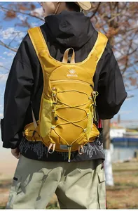 Dettaglio di uno zaino da trekking giallo ultraleggero indossato da un uomo