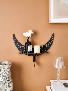 Modern black crescent moon wooden shelf with stars, displaying fragrance oil and candle.