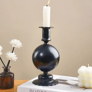 Macro view of a black spiral glass candlestick holder on a book in an elegant setup