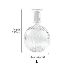 Geribbelde glazen kandelaar L: 16,6cm hoog, 11,8cm breed. Minimalistische decoratie.