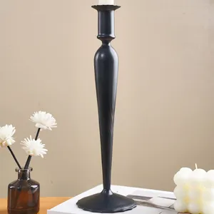 Detailed view of an elegant black tapered candle holder in a modern home setting