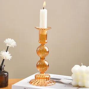 Close-up of a ribbed amber glass candle holder featuring an elegant multi-tiered bubble design.