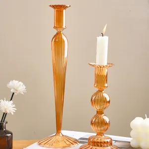 Close-up view of amber ribbed glass candle holders featuring an elegant striped texture