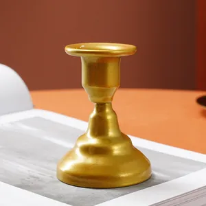Detailed macro shot of a golden iron candle holder with elegant metallic finish