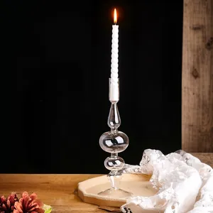 Dettaglio di un candeliere in vetro vintage stile francese con una candela bianca accesa