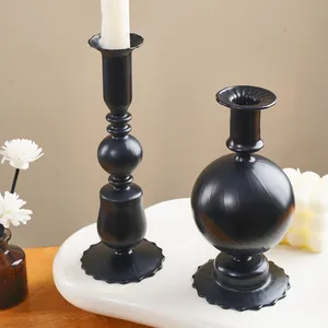 Close-up of minimalist black striped glass candle holders for wedding table decoration