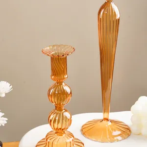 Close-up of amber ribbed glass candle holders with elegant vertical stripe texture.