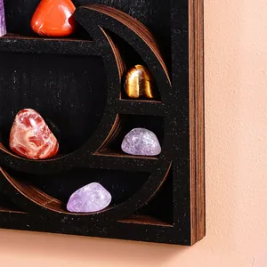 Detail view of a moon-shaped wooden wall shelf featuring natural crystal stones