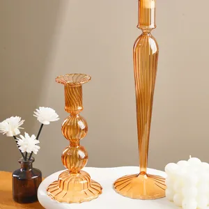 Detailed view of elegant amber ribbed glass candlesticks for wedding and festive table decor