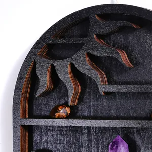 Macro view of black wooden sun-shaped wall shelf detail showing crystal display