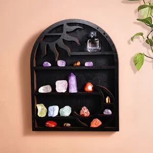 Black wooden arched display shelf with sun and moon carvings showcasing healing crystals