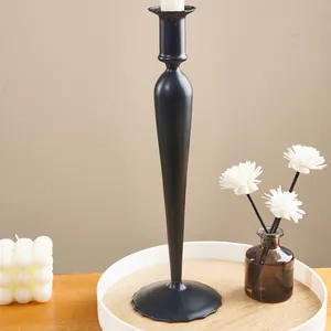 Sleek black long stem candle holder displayed in a minimalist home decor setting.