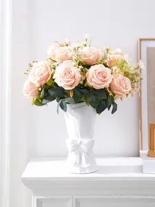 Elegant champagne pink artificial roses set in a white ceramic vase with bow detail decoration