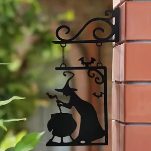Detailed view of black Halloween witch cauldron silhouette iron wall hanging on brick