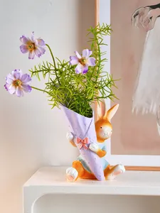 Close-up of cute resin rabbit figurine vase holding a purple bouquet for Easter home decor