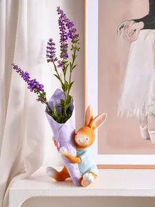 Detailed view of a cute resin Easter bunny figurine holding a purple lavender flower vase.