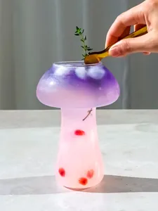 Close-up of a creative mushroom-shaped glass cocktail with purple gradient drink