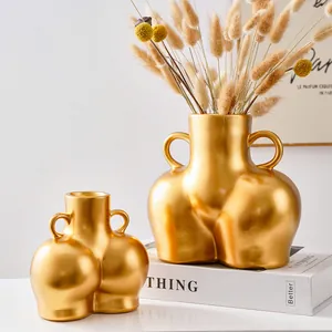 Jarrón creativo de resina dorada con forma de cuerpo y asas para decoración nórdica
