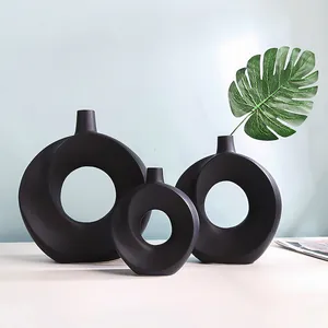 Detailansicht der glatten mattschwarzen Textur nordischer minimalistischer Donut-Vasen.