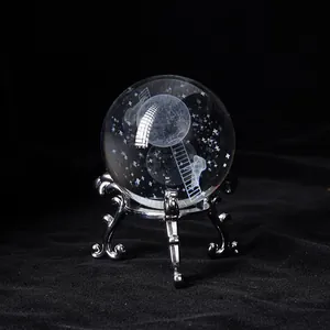 Detailed macro view of internal laser-engraved crystal ball featuring moon and stars motif