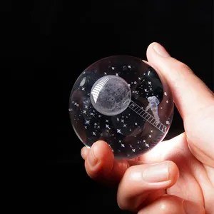 Macro view of 3D laser engraved astronaut and moon inside clear crystal ball