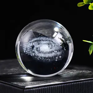 Close-up of a laser-engraved galaxy inside a clear crystal ball ornament