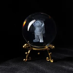 Detailed close-up view of a laser-engraved 3D astronaut inside a clear crystal glass ball