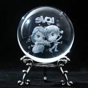 Detail of a 3D laser-engraved crystal ball with a cute couple and LOVE text on a metal stand
