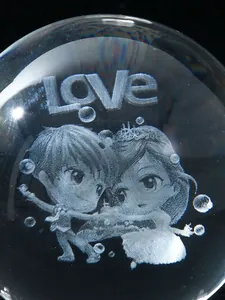 Macro detail showing laser engraved romantic couple and LOVE text inside a crystal ball