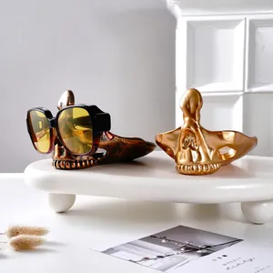 Porta occhiali a forma di teschio in resina, finiture bronzo e oro, decoro ufficio