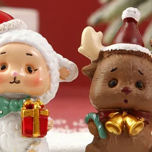 Primer plano de figuritas festivas de ovejas y renos con caja de regalo y campanas.