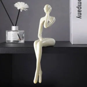 Dettaglio di statuina pensatore in resina color crema con finitura galvanica liscia.