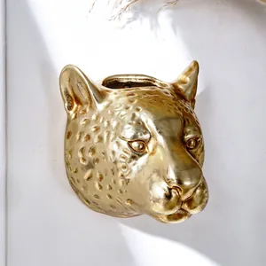 Detailed close-up view of a golden leopard head wall planter for modern home decor