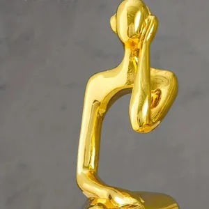 Creative golden abstract human figurine sculpture for modern home and office desk decor