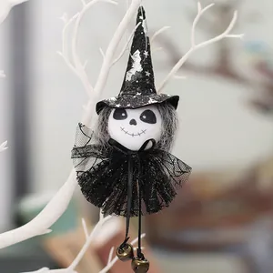 Close-up detail of Halloween witch doll hanging ornament with black lace and metal bells