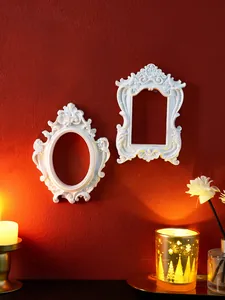 Detailed view of European style vintage embossed white wall decor frames on red wall