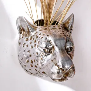 Close-up of metallic silver leopard head wall planter with intricate spotted details.