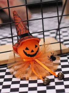 Macro detail of a cute Halloween pumpkin hanging ornament with a witch hat and bells.