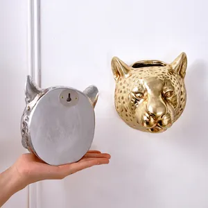 Golden leopard head wall decor showing front detail and mounting hole on the back